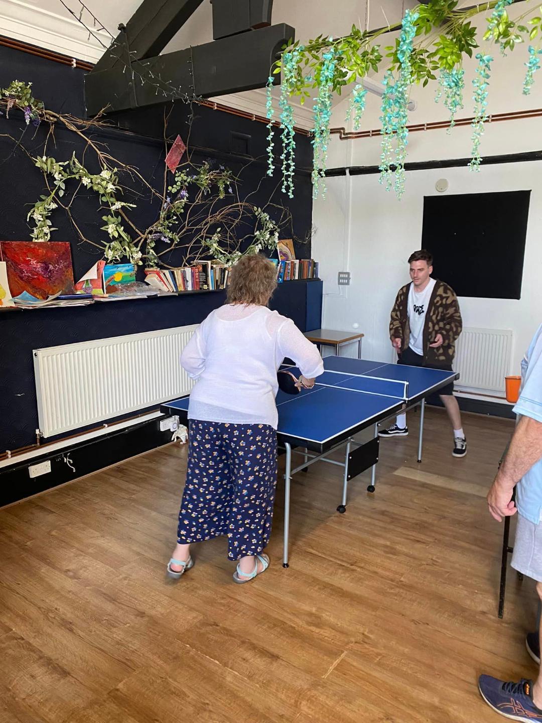 2 people playing table tennis