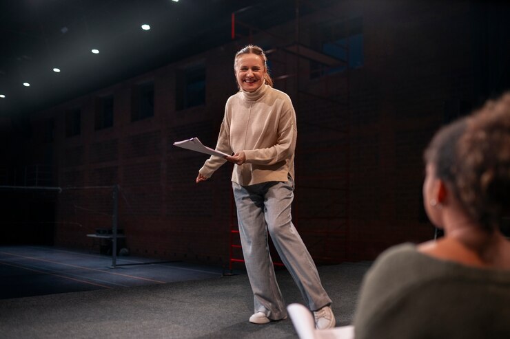 Woman reading a script on stage